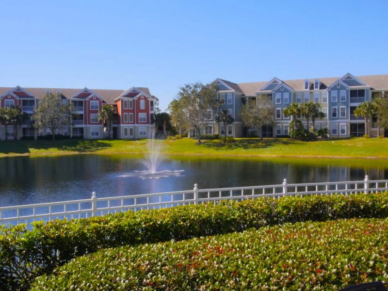This image shows the calm lake and lush natural surroundings that overlook the gigantic TGM Bay Isle Apartments in St Petersburg, FL.