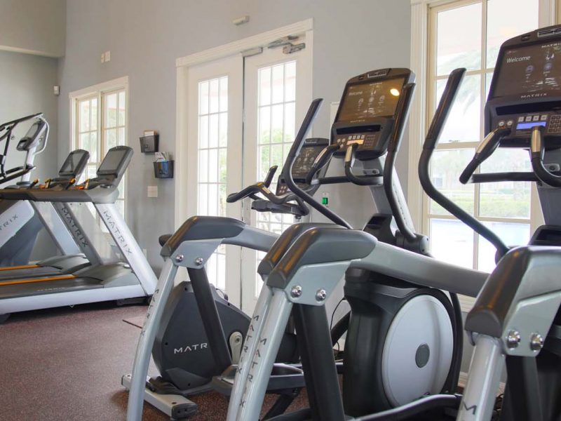This image showcases the commercial fitness with State-of-the-art athletic club with equipment that is essential for community amenities and offering a high-quality cardio machine.