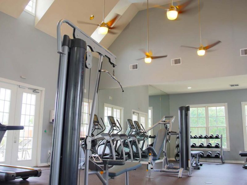 This image showcases a range view of commercial fitness with State-of-the-art athletic club with equipment that is essential for community amenities and offering machines for fitness enthusiasts and professionals. The Athletic Club also has an architectural space for comfy ambiance.